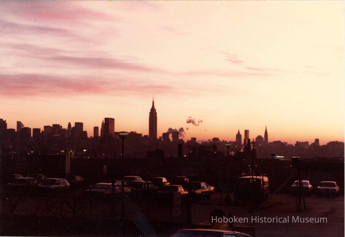 Digital scan of color photo of a sunrise view of the Manhattan skyline from Jersey City Heights, Jersey City, no date, circa 1970-1980. picture number 1