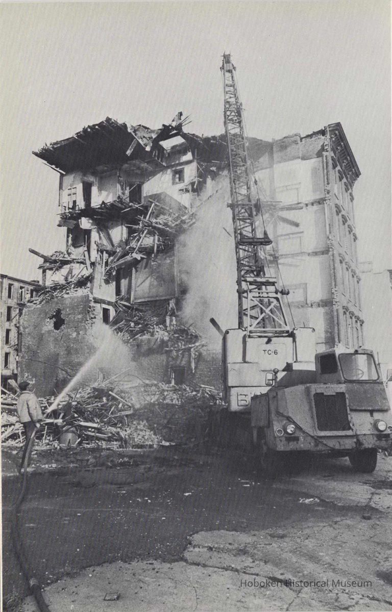 Reference image of printed photo image of building demolition from pg [32] of archives catalog 2002.026.0002, Hoboken, ca. 1975. picture number 1