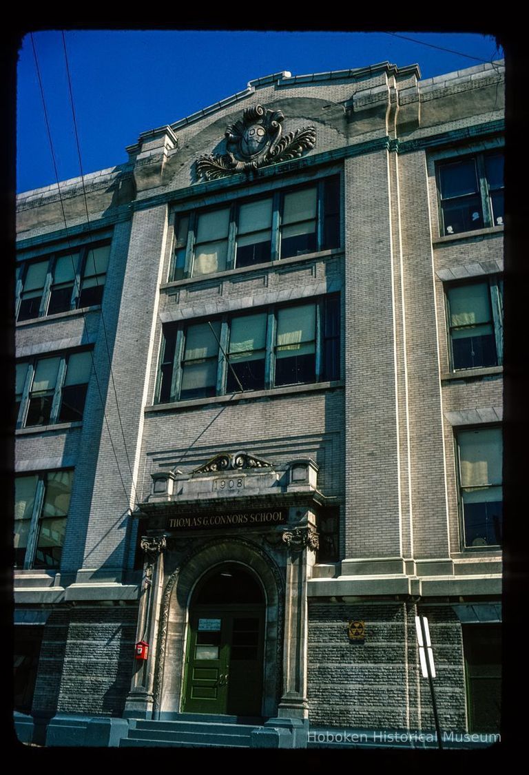 Color slide of eye-level view façade, portico, pediment and frieze reading 