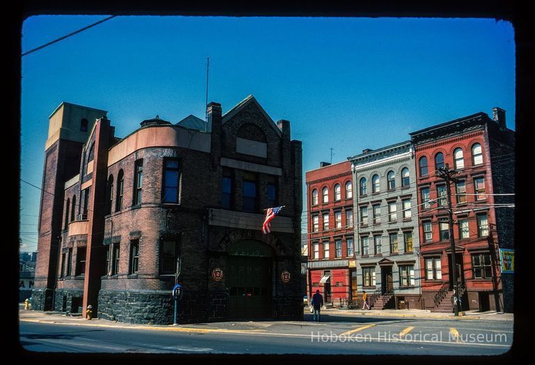 Color slide of eye-level view of the Hoboken Fire Department Engine Company No. 3 (Truck 2) fire station façades at 501 Observer Highway at the juncture with Newark and showing row houses at 510, 512 and 514 Observer Highway picture number 1