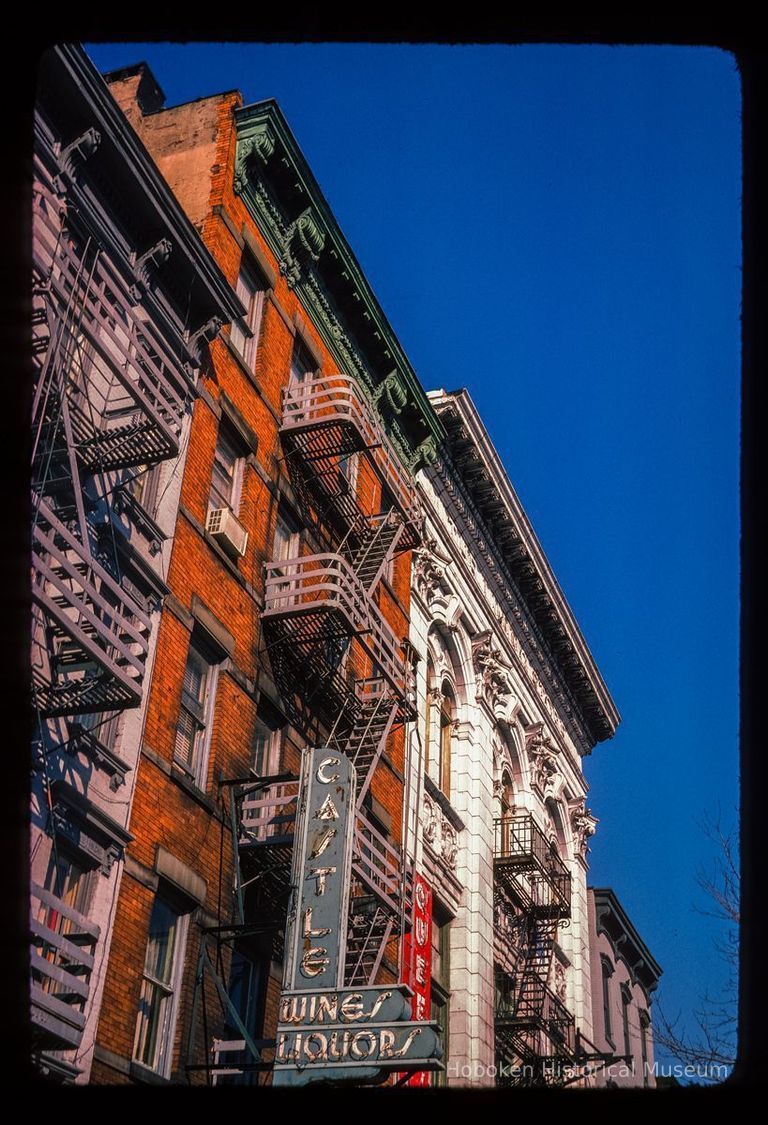 Color slide of detail view of façades, cornices and fire escapes at 410 Washington and the Lining Store building at 412 Washington between 4th & 5th showing a sign reading 