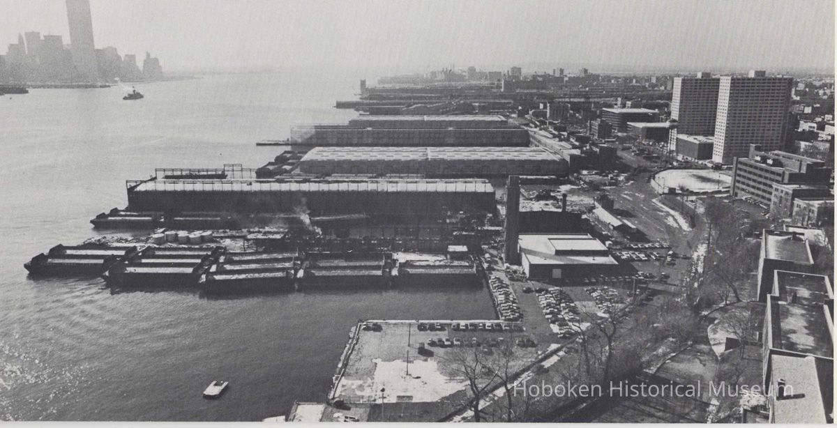 Reference image of printed photo image of aerial view of waterfront looking south from pg 29 of archives catalog 2002.026.0002, Hoboken, ca. 1975. picture number 1