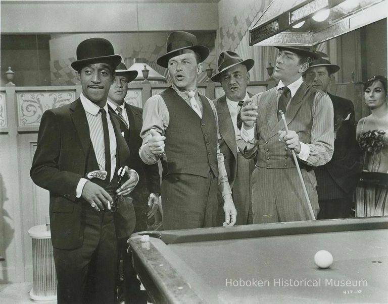 Black-and-white photo, movie still, of Sammy Davis, Jr., Frank Sinatra & Dean Martin in film 