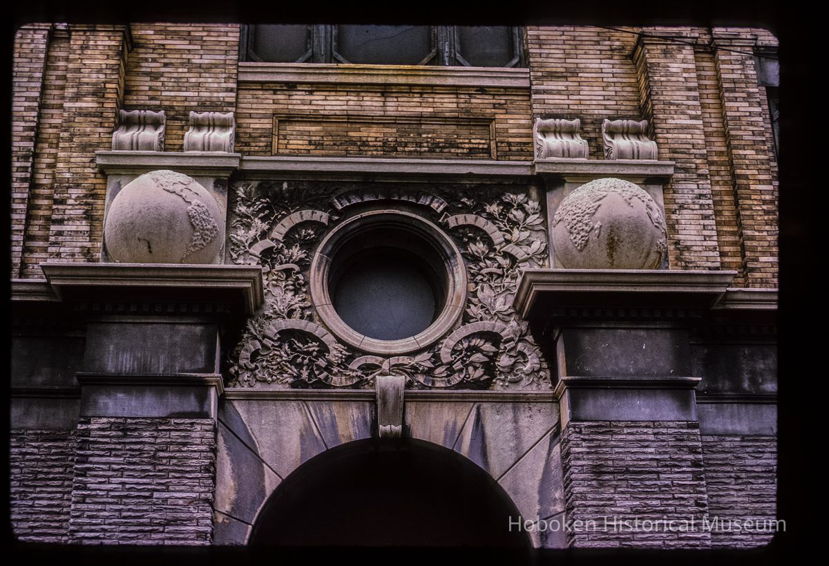 Color slide of detail view of portico keystone, oculi window, pilasters, and capitals of Public School No. 7 building at 80 Park on the SW corner with Newark picture number 1