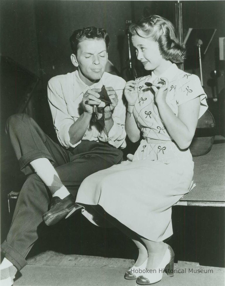 Black-and-white photo of Frank Sinatra and Jane Powell in a posed radio studio 'candid' publicity shot, New York, no date, ca. 1946-47. picture number 1