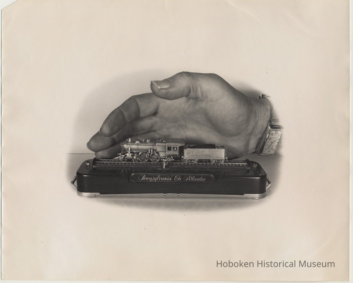 photo 1: hand from right behind model; 8 x 10