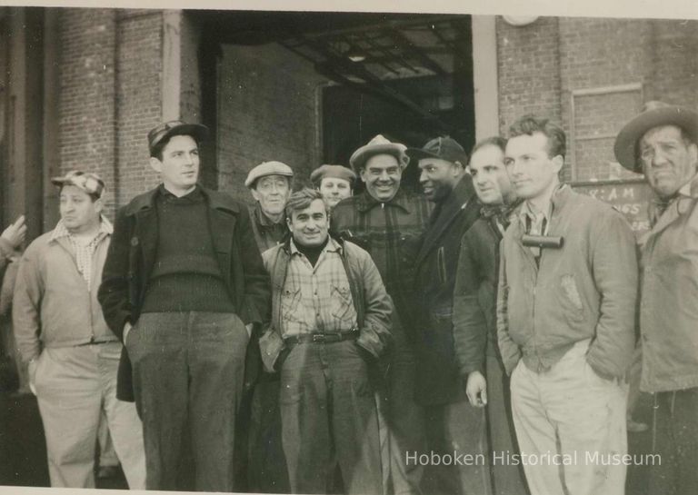 character actors and extras posed near filming location near Pier C