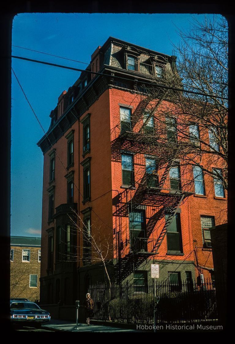 Color slide of eye-level view of side and rear façades, mansard roof, and fire escape at 636 Hudson on the SW corner of 7th picture number 1