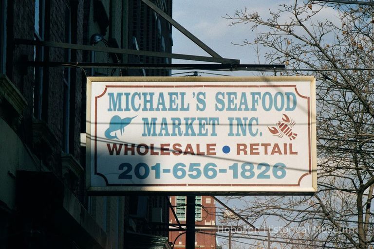 Color photo of a hanging sign for Michael's Seafood Market, Inc., 226 Willow Avenue, Hoboken, Jan. 3 & 4, 2002. picture number 1