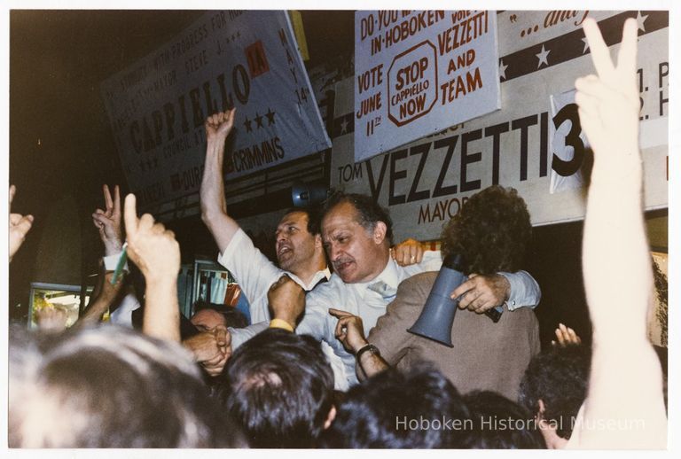 Color photo of mayoral candidate Tom Vezzetti with supporters in front of his campaign headquarters on election night, Hoboken, [June 11, 1985]. picture number 1