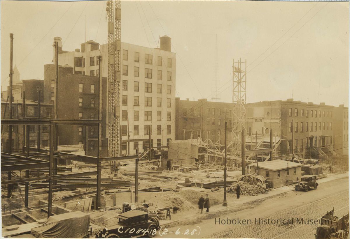 Sepia-tone photo of steel frame erection on the site for the Fabian Theatre, southeast corner of Newark & Washington Sts., Hoboken, Feb. 6, 1928. picture number 1