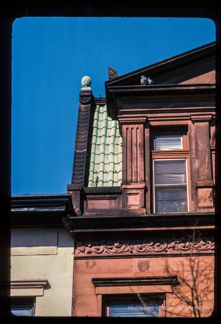 Color slide of detail view of mansard roof, pediment, pilasters, cornice, frieze and window head at 512 Hudson between 5th and 6th picture number 1