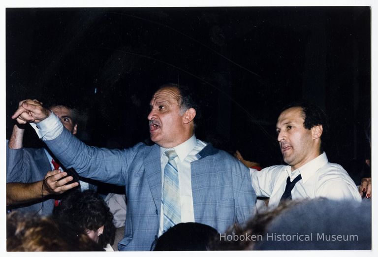 Color photo of mayoral candidate Tom Vezzetti in front of City Hall with supporters on election night, Hoboken, [June 11, 1985]. picture number 1