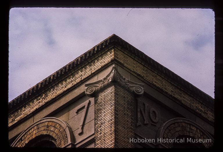 Color slide of detail view of brick pilaster, quoins, gauged arches, dentils and cornice reading 