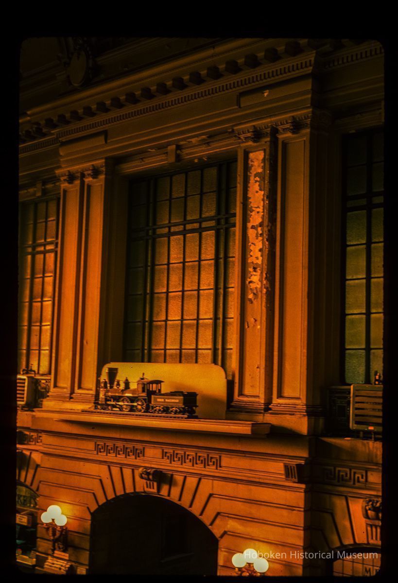 Color slide of interior detail view of Erie Railroad model train above the north door of the Lackawanna Terminal waiting room picture number 1