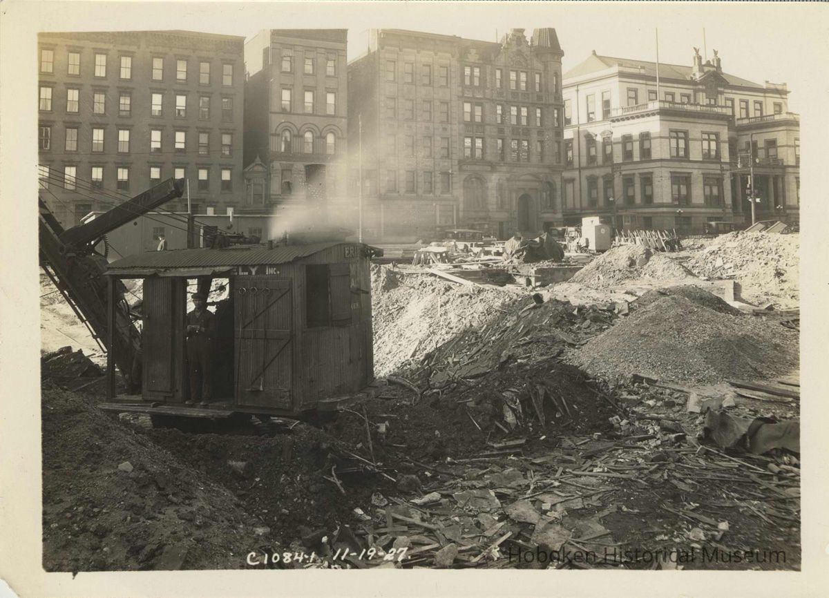 Sepia-tone photo of foundation preparation on the site for the Fabian Theatre, southeast corner of Newark & Washington Sts., Hoboken, Nov. 19, 1927. picture number 1