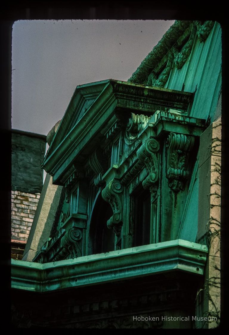 Color slide of close-up view of mansard roof, gable dormer, pediment, brackets and cornice at 905 Hudson between 9th and 10th picture number 1