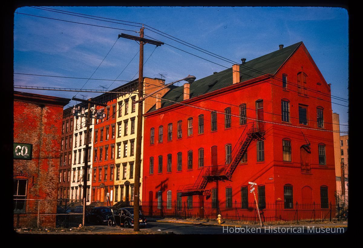 Color slide of eye-level view of industrial building façade with fire escape at 55 Bloomfield and adjacent four row houses along Bloomfield on the NE corner of Bloomfield and Observer Highway picture number 1