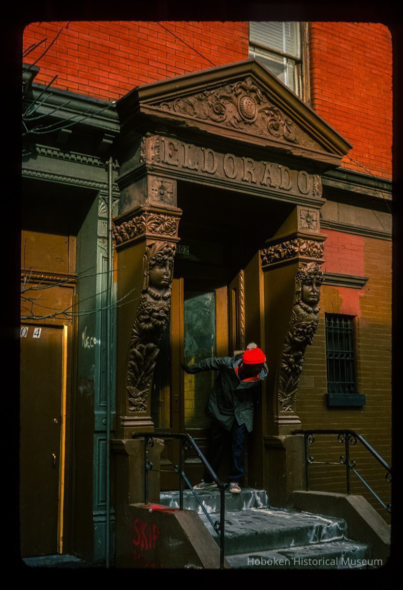 Color slide of close-up view of bracketed portico, pediment and frieze reading 