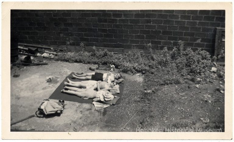 photo 1 image: three women sunbathing, 65 Paterson Ave.