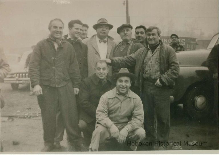 character actors and extras posed near pier shooting location