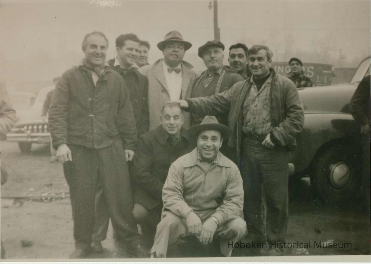 character actors and extras posed near pier shooting location