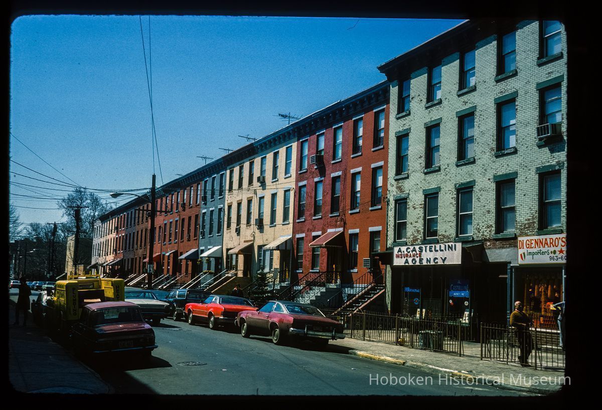 Color slide of eye-level view of row houses on the W side of Garden looking S with Di Gennaro's Italian Deli at 536 Garden and A. Castellini Insurance Agency at 534 Garden picture number 1
