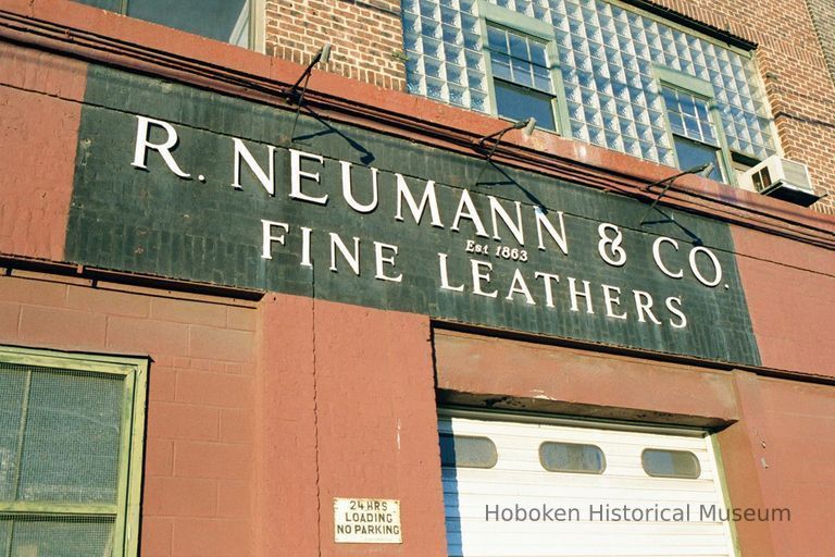 Color photo of a wall sign for R. Neumann & Co., Est. 1883, Fine Leathers, 300 Observer Highway, Hoboken, Jan. 3 & 4, 2002. picture number 1