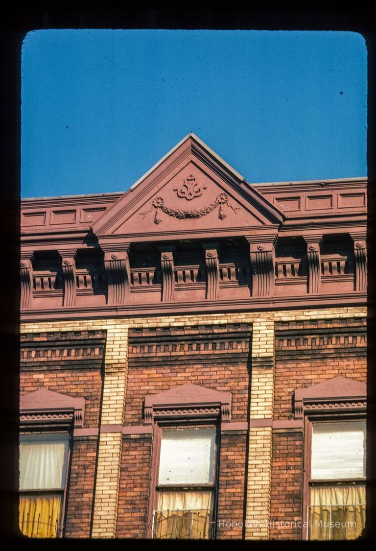 Color slide of detail view of pediment, cornice, brackets and window heads at an unidentified location picture number 1