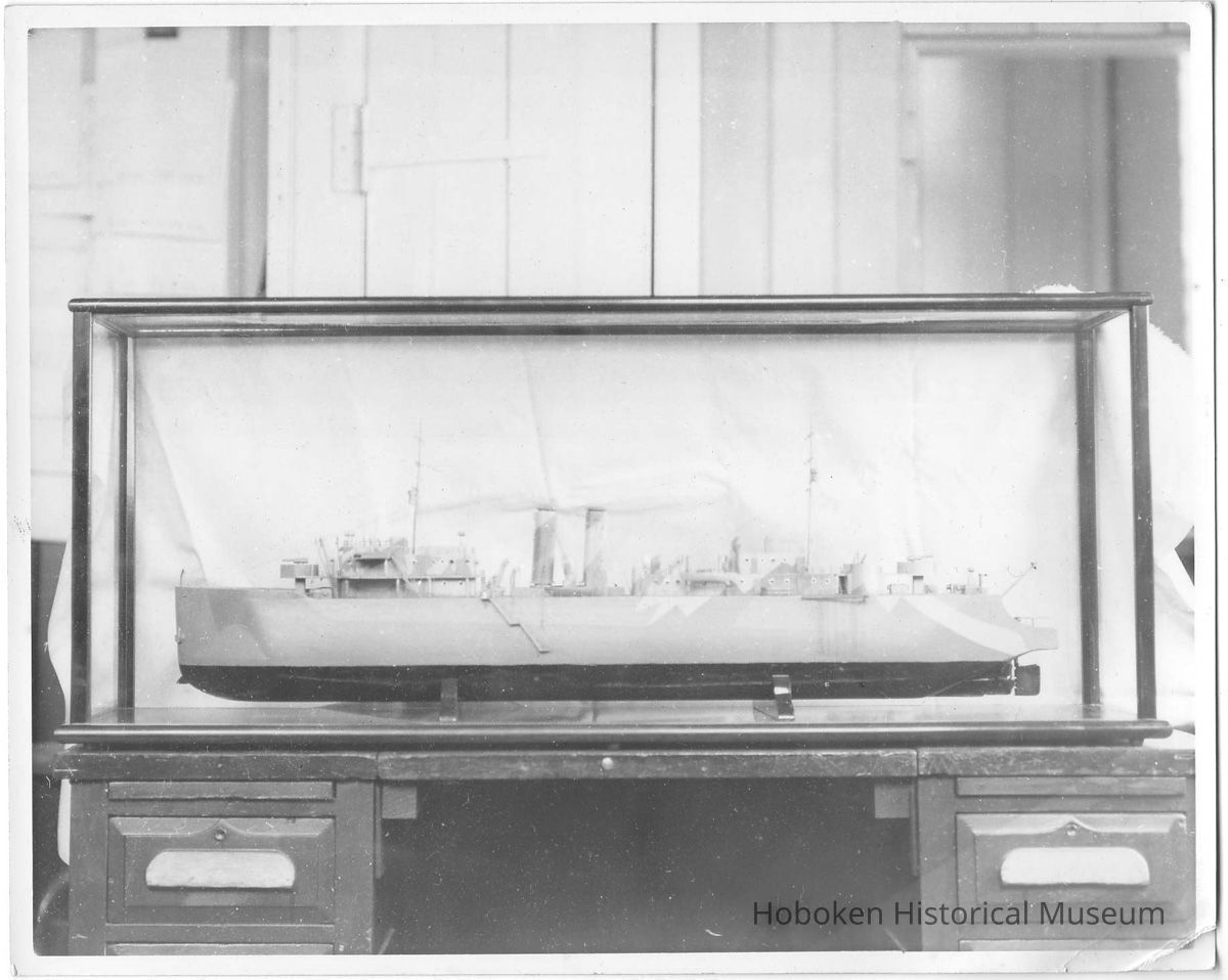 B+W photo of a ship model with camouflage design in a display case, Hoboken, no date, ca 1940-45. picture number 1