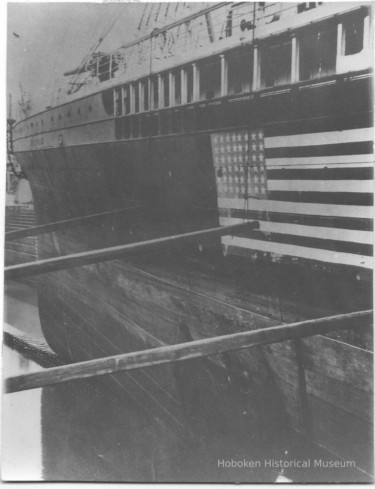 B+W photo of an unknown ship in dry dock with a 48-star flag painted on its side, Hoboken, no date, ca. 1940. picture number 1