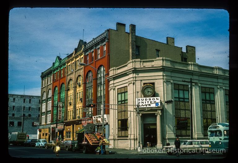 Color slide of eye-level view of façade of the Up-Town Bank of Hoboken Trust Company building at 1400 Washington occupied by Hudson United Bank on the NW corner of Washington & 14th and row houses along 14th picture number 1