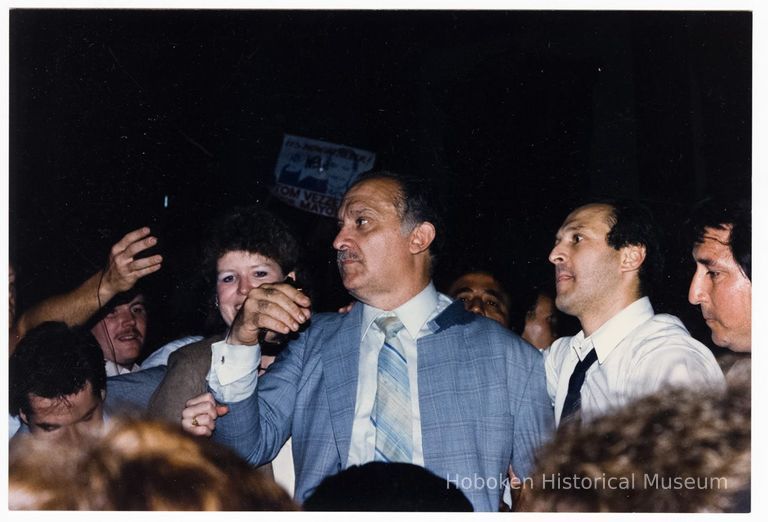 Color photo of mayoral candidate Tom Vezzetti in front of City Hall with supporters on election night, Hoboken, [June 11, 1985]. picture number 1