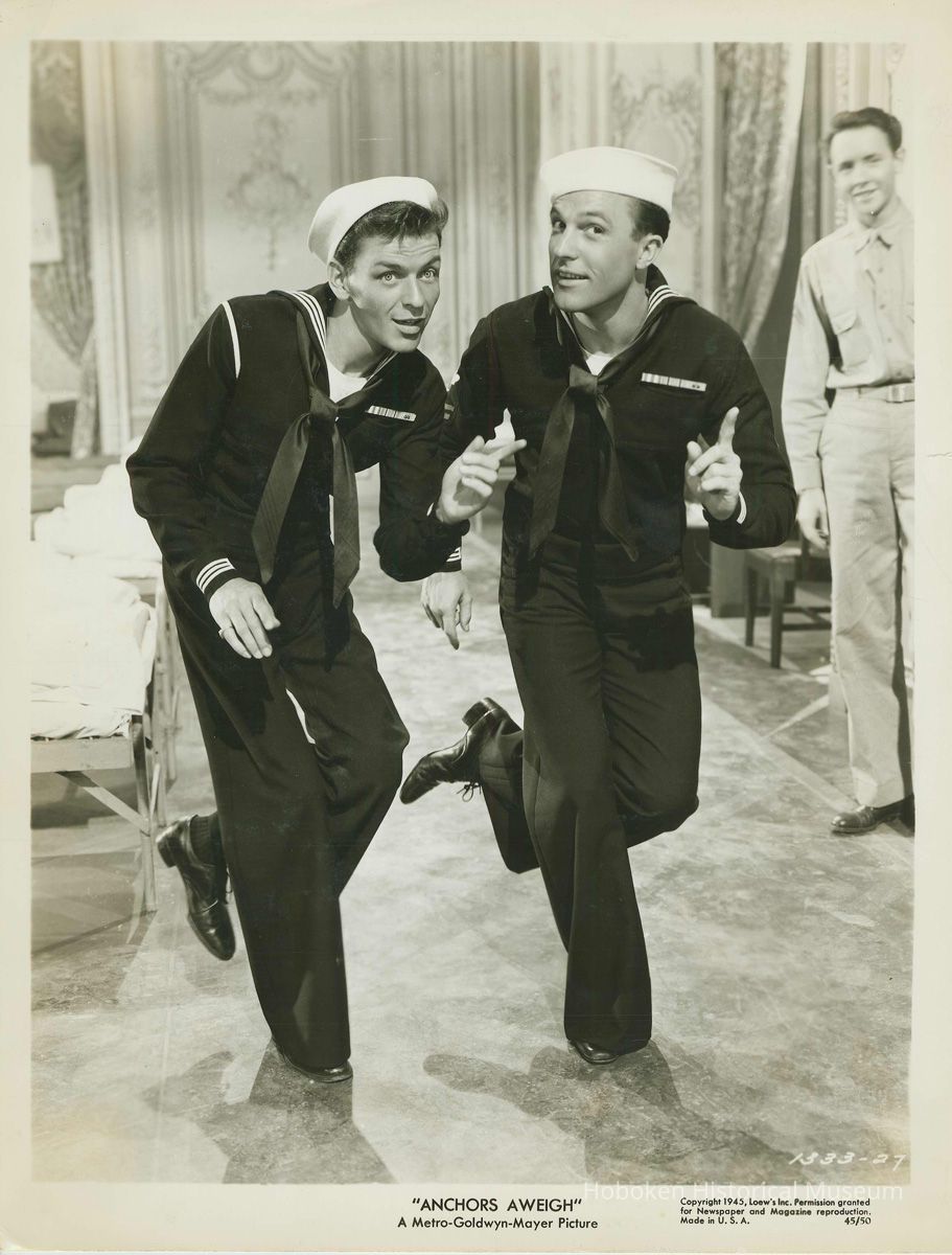 Sepia-tone photo, movie still, of Frank Sinatra & Gene Kelly in film 