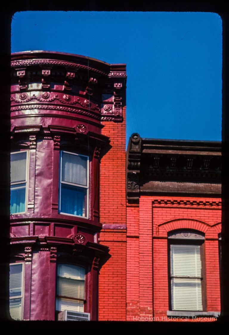 Color slide of detail view of cornices, bay windows and gauged arches at 1034 and 1036 Washington on the SW corner with 11th picture number 1