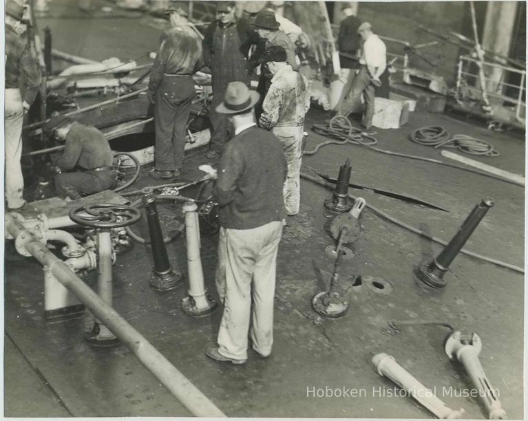 B+W photo showing workers inspecting damage on the main deck on unidentified vessel at the Bethlehem Steel Shipyard, Hoboken Division, no date, ca. 19 picture number 1