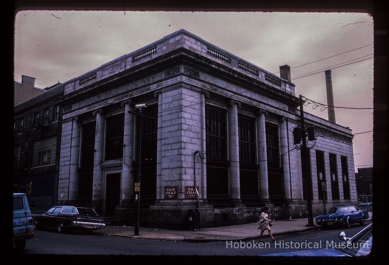 Color slide of eye-level view of front and side facades of the Jefferson Trust Company building at 313 1st on the SE corner of 1st and Clinton occupied by G&S Coat Company picture number 1