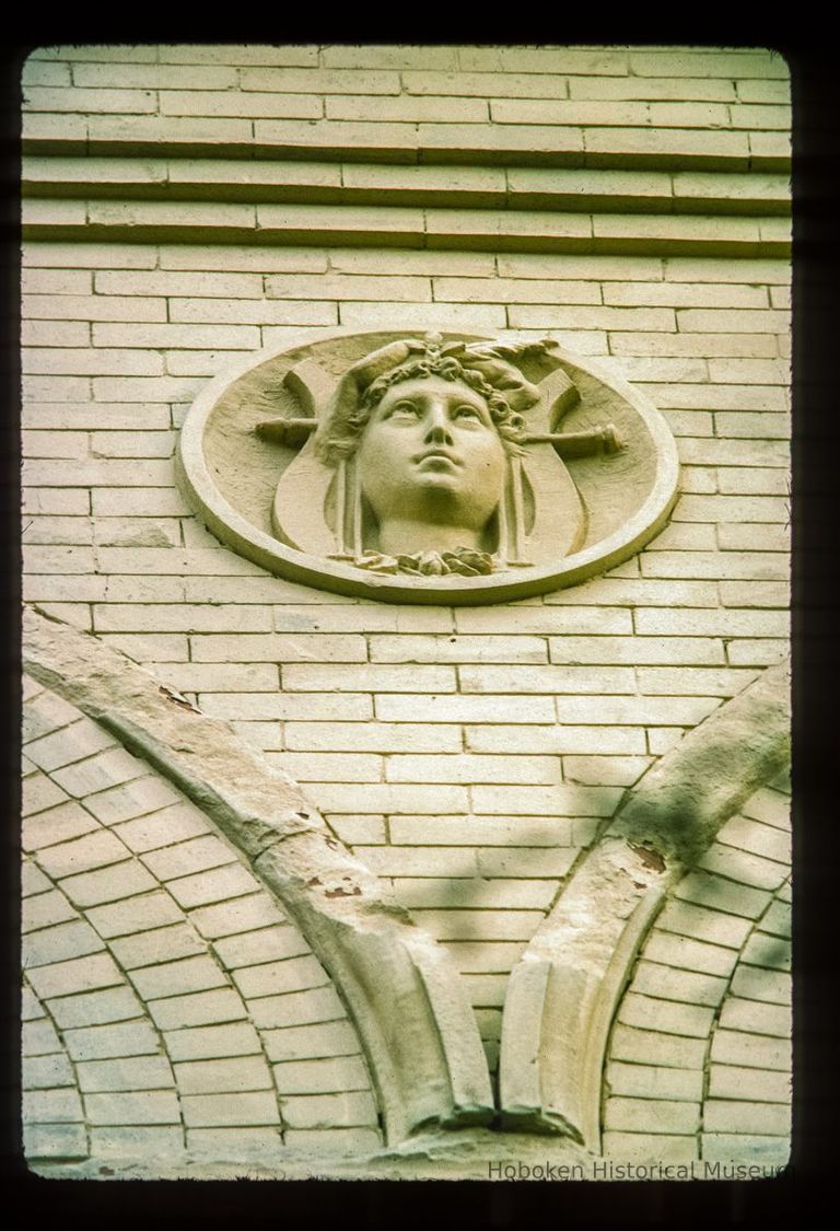 Color slide of close-up view of roundel on the façade of the Columbia Club at 1101 Bloomfield on the corner of 11th and Bloomfield picture number 1