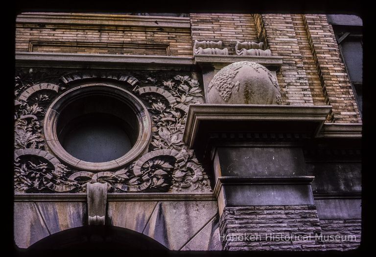 Color slide of detail view of portico keystone, oculi window, pilasters, and capitals of Public School No. 7 building at 80 Park on the SW corner with Newark picture number 1