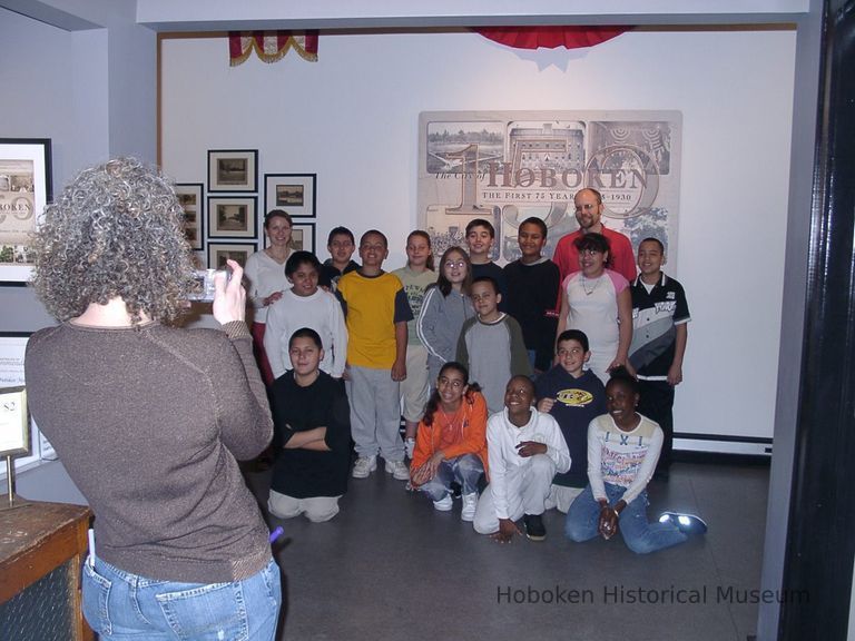 Digital image of a class posing at exhibition, Hoboken, The First Seventy-Five Years: 1855-1930, HHM, Hoboken, April 22, 2005. picture number 1