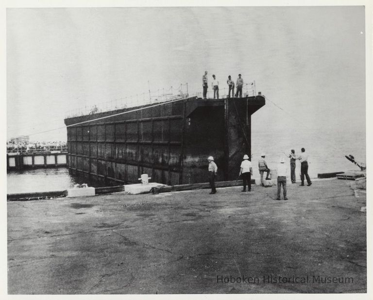 photo 1: floating gate of graving dock being positioned