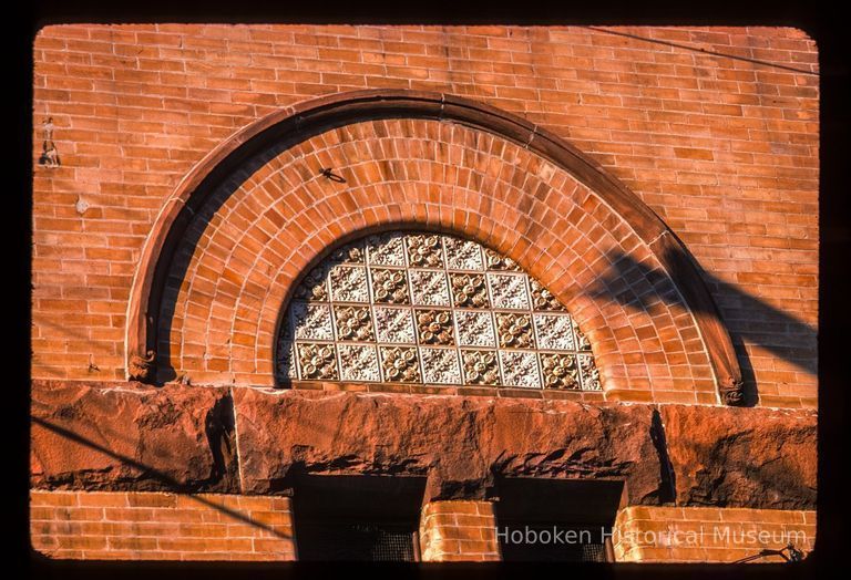 Color slide of close-up view of brickwork, gauged arch and decorative tiles on the façade of the First Baptist Church at 901 Bloomfield on the corner of Bloomfield and 9th picture number 1