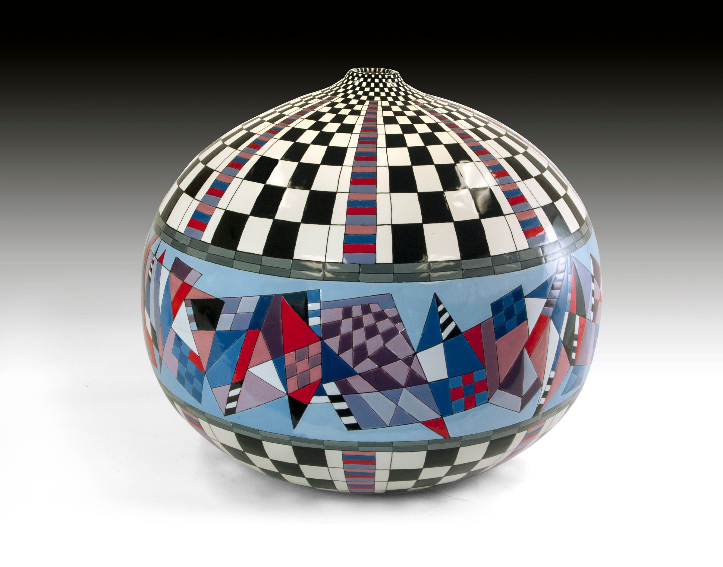 The image depicts a highly intricate spherical sculpture, predominantly featuring a mesmerizing pattern of checkered black and white squares at the top, transitioning to vibrant triangles and rectangular shapes in shades of blue, red, and purple, creating a stunning visual contrast and 3D illusion on a smooth, reflective surface.