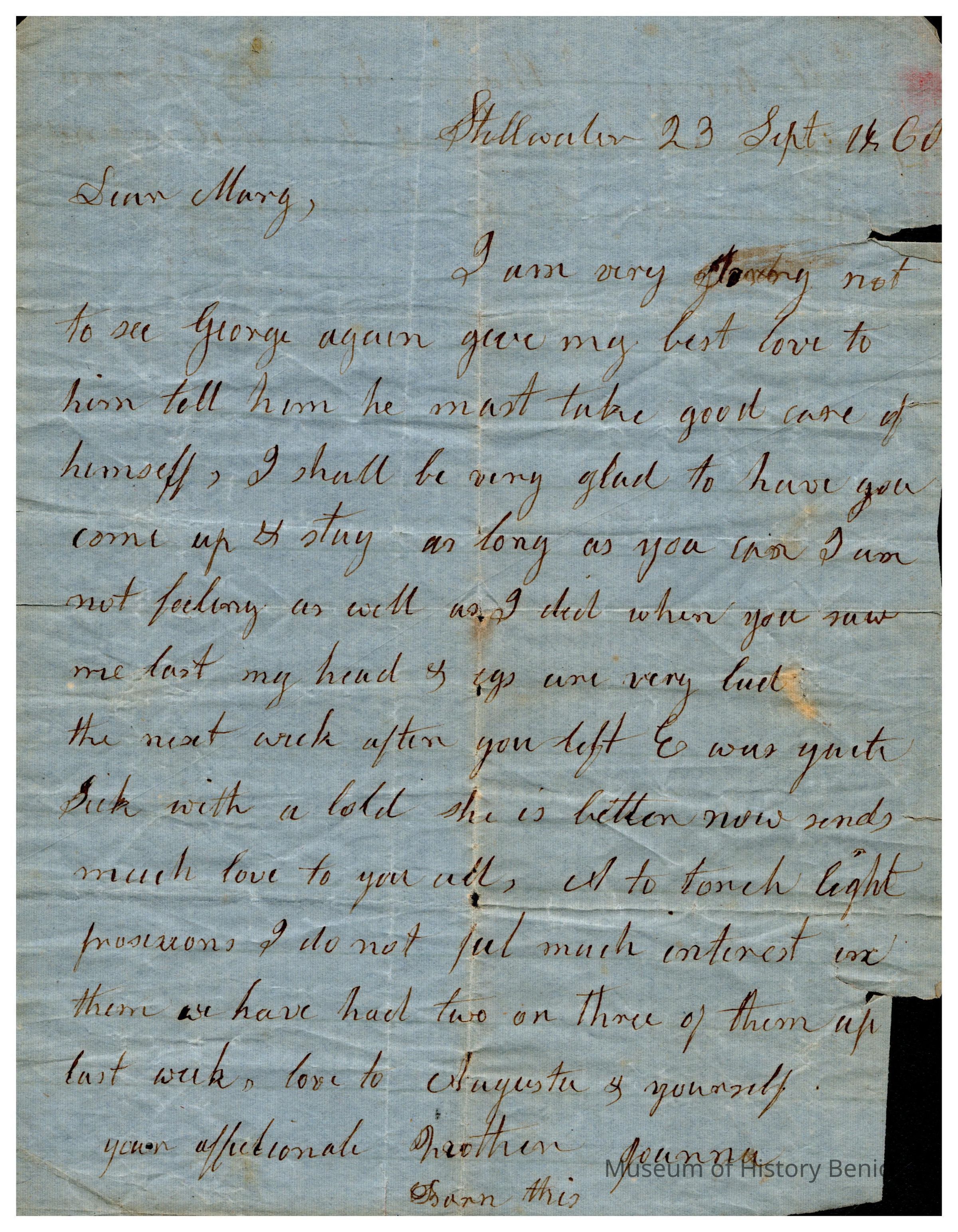 The image displays a handwritten letter dated 23rd September 1860, from Joanna Evans to someone named Mary. The letter is penned on aged blue paper, with the ink appearing slightly faded, indicative of its historical context. Joanna expresses her regret about not seeing "George Morton" and sends her best wishes, advising him to take care. She mentions feeling unwell since Mary left and discusses light provisions, noting a lack of interest in them. Joanna also sends love to Mary’s relatives, specifically mentioning others. Despite the letter showing signs of wear, it retains a heartfelt tone throughout.