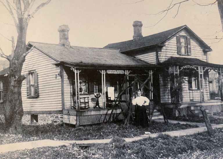 Eliza Jane Eldridge in front of her home in Angelica, New York, where she ran her dressmaking business. The sign above the door reads, "Dress Making" (Copy).