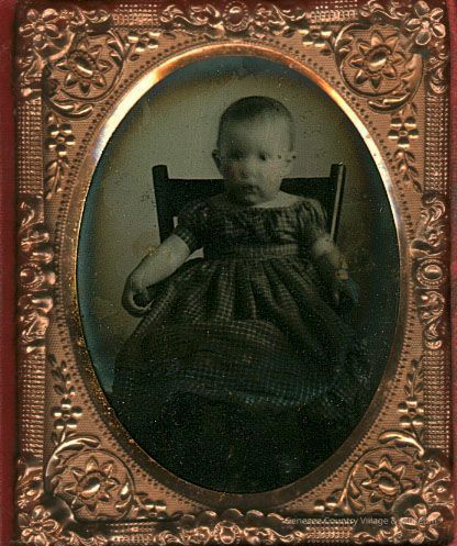 Baby in Checked Dress in High Chair