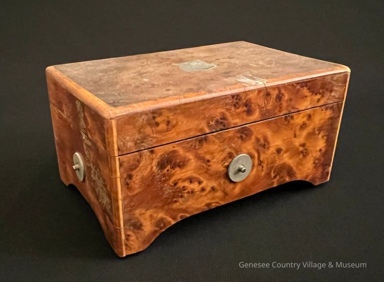 Box closed with pewter disks visible