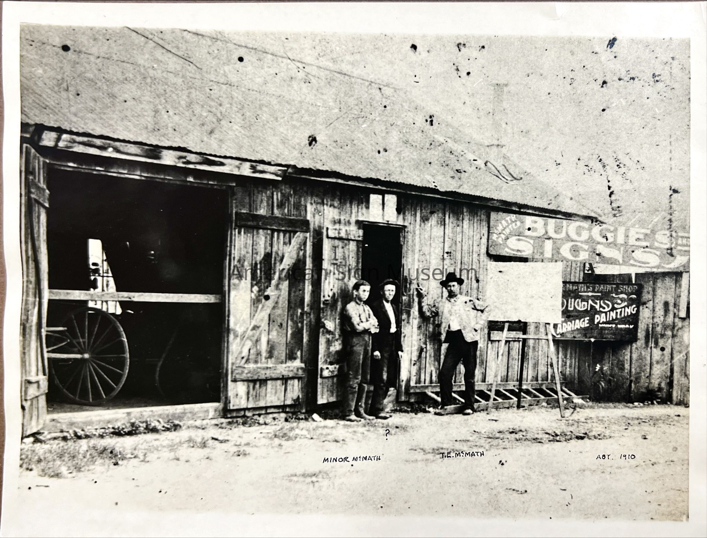 Sign Shop Exterior with Workers - Photograph picture number 1