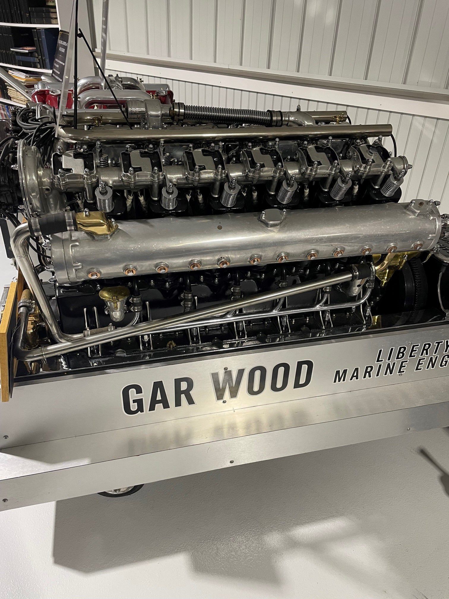 The image shows a complex Gar Wood Liberty marine engine, featuring multiple cylinders and intricate metal components.