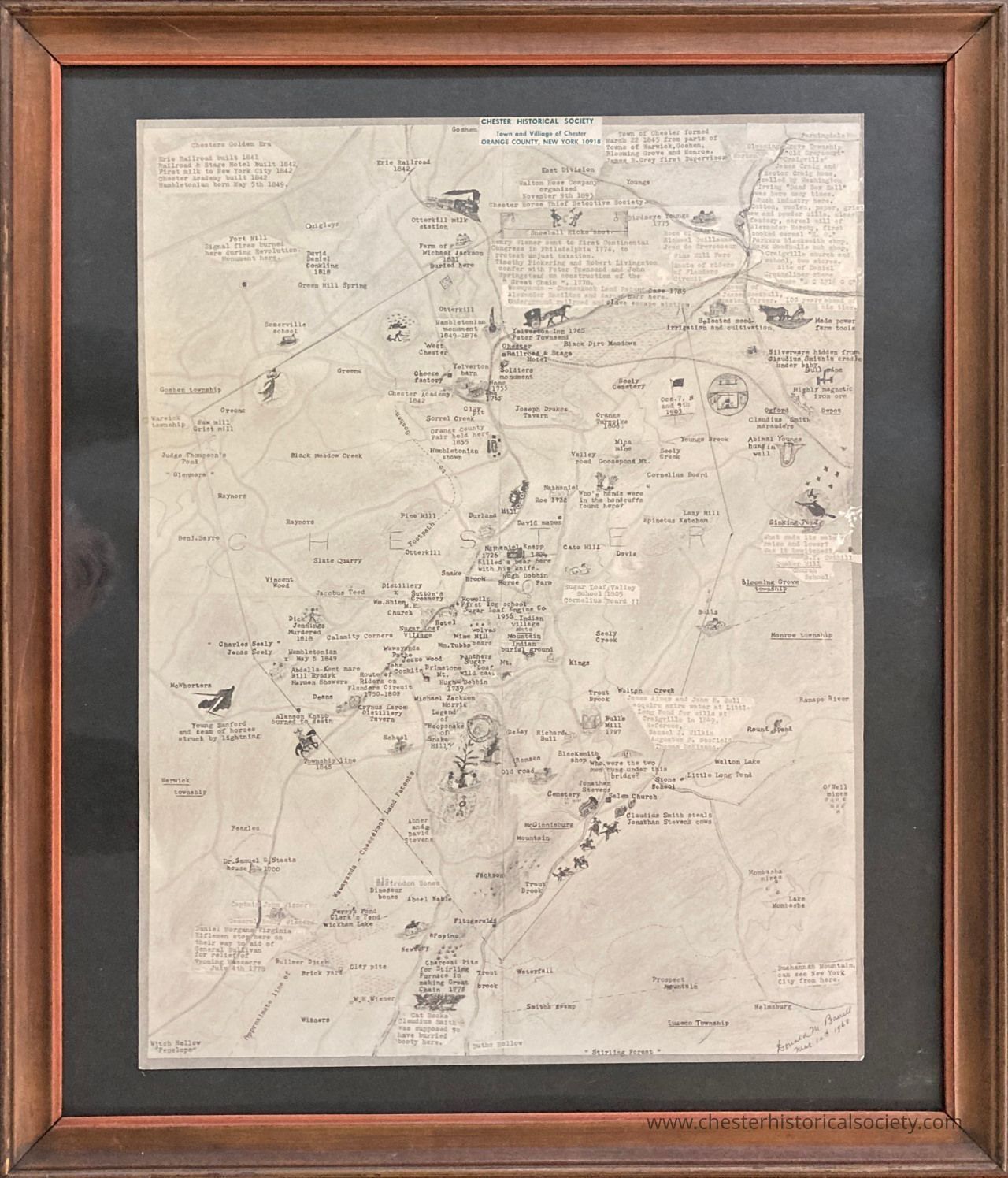 A framed Map of The the Town of Chester with many historical notations - recto: The image is a framed historical map with a “Chester Historical Society” label depicts historical feature of the Town of Chester in Orange County, New York. The map is hand-drawn by Donald Melville Barrell and marked with various labels identifying locations such as farms, residences, landmarks, roads, and natural features like streams and hills, all detailed in small, neat handwriting. Various small illustrations of animals, trees, and structures are scattered throughout, adding visual interest and context to the geographical information